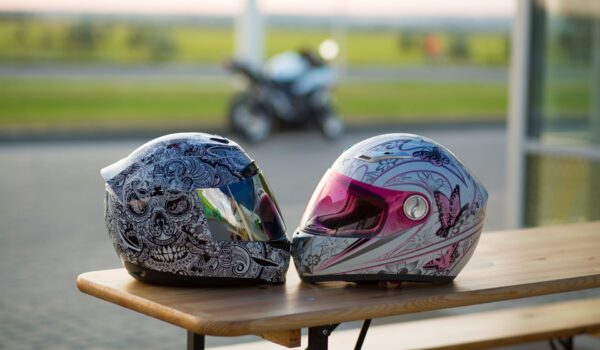 Biker,Romance.,Male,And,Female,Motorcycle,Helmets,On,The,Background